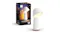 A Philips Hue lamp beside retail box packaging A Philips Hue lamp beside retail box packaging