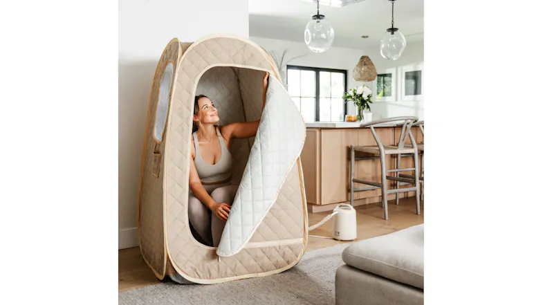 A view of the sauna with a lady sitting inside it A view of the sauna with a lady sitting inside it