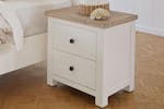 Taylor 2 Drawer Bedside Table shown with a decorative shell and basket sitting on it, beside a bed. Taylor 2 Drawer Bedside Table shown with a decorative shell and basket sitting on it, beside a bed.