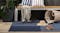Horizontal outdoor shot of navy rug under bench with accessories around Horizontal outdoor shot of navy rug under bench with accessories around