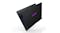 Partially closed laptop with purple keys and matte black finish Partially closed laptop with purple keys and matte black finish