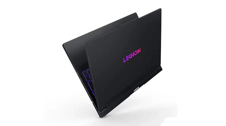 Partially closed laptop with purple keys and matte black finish Partially closed laptop with purple keys and matte black finish