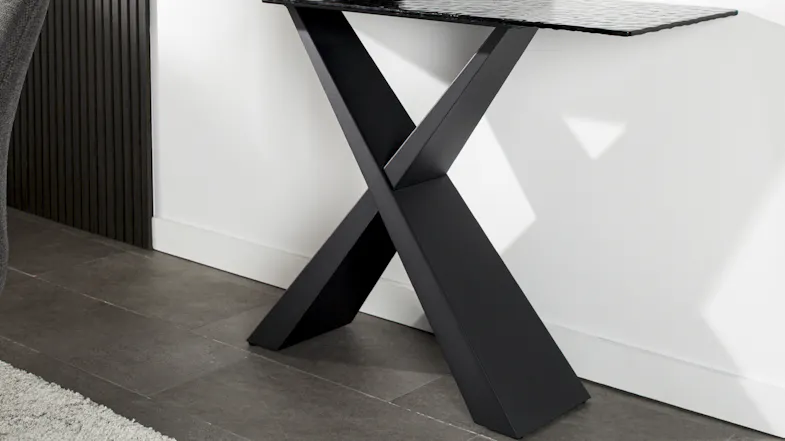 Detailed view of the console table’s intersecting X-shaped black metal base, highlighting its sturdy design Detailed view of the console table’s intersecting X-shaped black metal base, highlighting its sturdy design