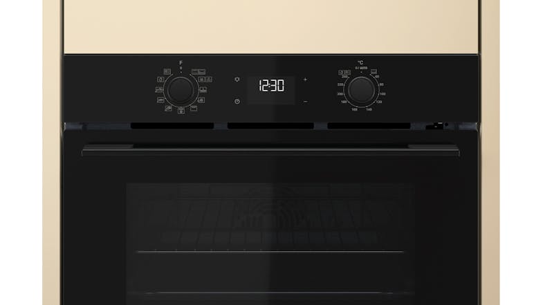 Close-up view of the Whirlpool oven with a black panel and a glass window Close-up view of the Whirlpool oven with a black panel and a glass window