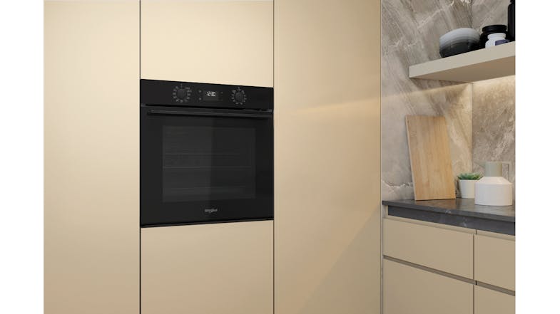 Side view of the Whirlpool oven mounted near the stone counter Side view of the Whirlpool oven mounted near the stone counter