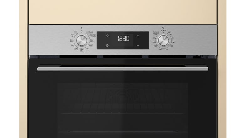 Close-up view of the Whirlpool oven with a black panel and a glass window Close-up view of the Whirlpool oven with a black panel and a glass window