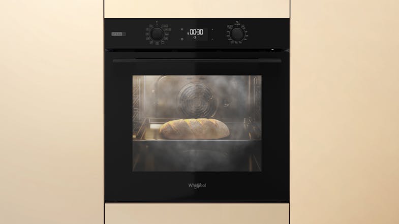 A Whirlpool oven is baking bread with visible steam A Whirlpool oven is baking bread with visible steam