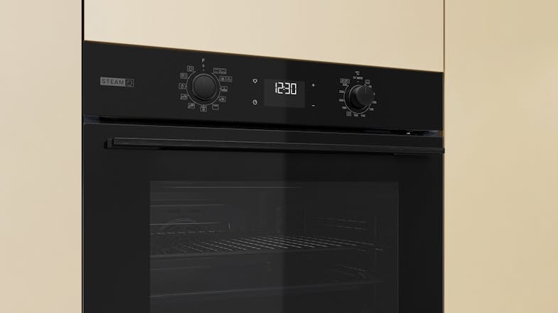 Close-up view of the Whirlpool oven mounted on the beige wall Close-up view of the Whirlpool oven mounted on the beige wall