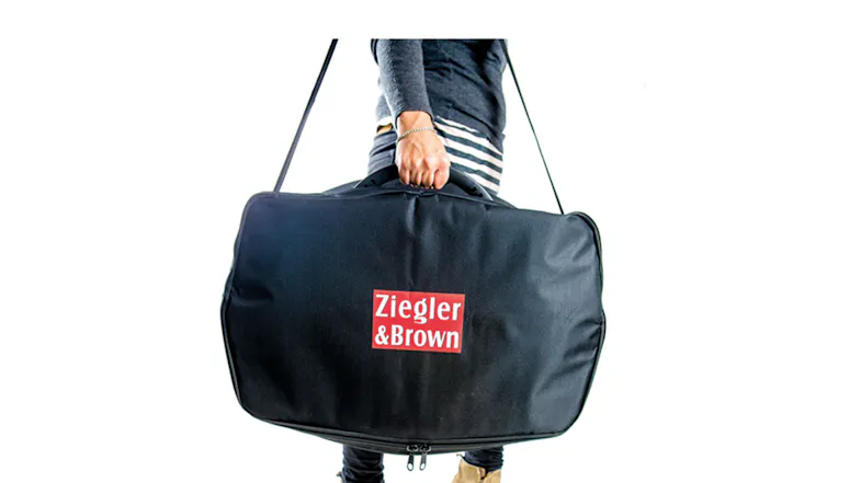 The Ziggy Portable 1 Burner BBQ Carry Bag being held by a hand The Ziggy Portable 1 Burner BBQ Carry Bag being held by a hand