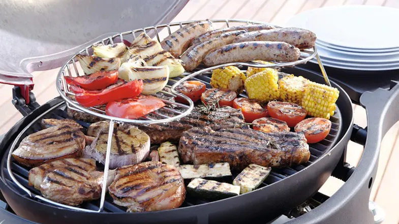 Ziggy Classic 2 Burner BBQ with a stainless steel warming rack holding grilled vegetables and sausages Ziggy Classic 2 Burner BBQ with a stainless steel warming rack holding grilled vegetables and sausages