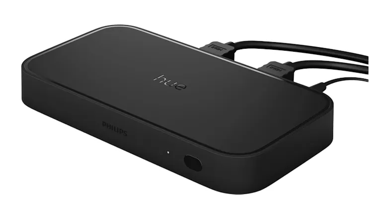 Angled view of the Hue Sync Box with HDMI cables connected to rear ports for setup Angled view of the Hue Sync Box with HDMI cables connected to rear ports for setup