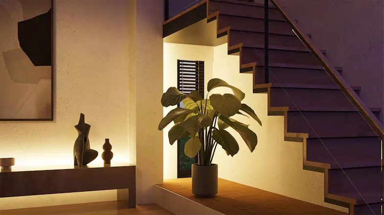Modern staircase area illuminated by warm white Philips Hue light strip installed along the wall and under the steps Modern staircase area illuminated by warm white Philips Hue light strip installed along the wall and under the steps