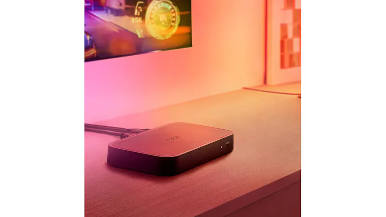 Philips Hue HDMI Sync Box on desk with gaming monitor and smart lights Philips Hue HDMI Sync Box on desk with gaming monitor and smart lights