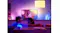 Couple watching TV in a living room with blue and pink ambient lighting Couple watching TV in a living room with blue and pink ambient lighting