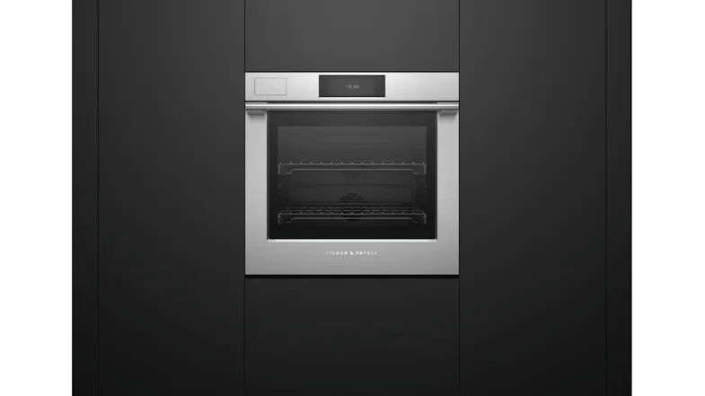 Steam oven integrated into matte black cabinetry. The door is closed, with a brushed silver frame Steam oven integrated into matte black cabinetry. The door is closed, with a brushed silver frame