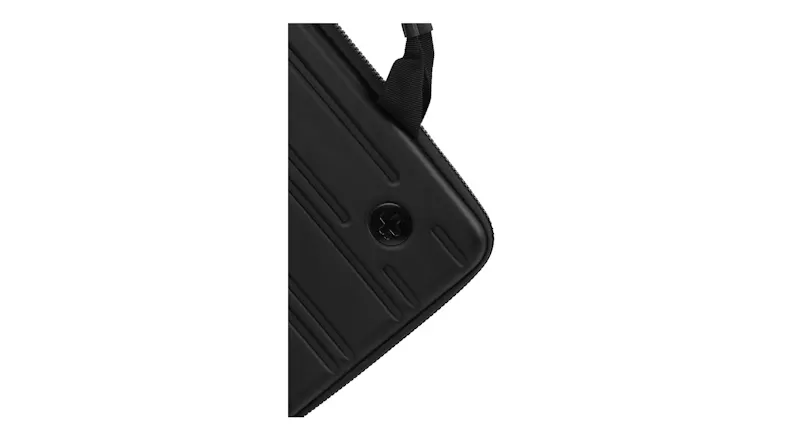 A corner detail of a black case showing grooves and a zipper edge A corner detail of a black case showing grooves and a zipper edge