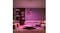 A cosy living room illuminated by purple pendant lights A cosy living room illuminated by purple pendant lights