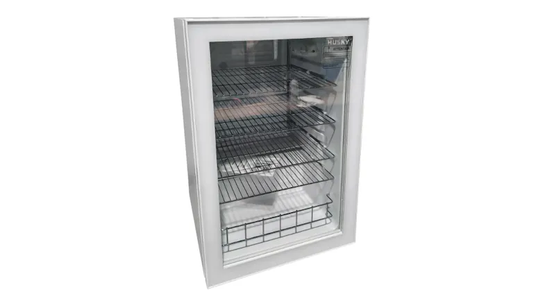 A right‑angled view of the Husky 130L white bar fridge, showing the glass door and empty interior A right‑angled view of the Husky 130L white bar fridge, showing the glass door and empty interior