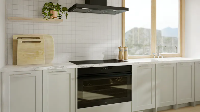 Oven and cooktop in a modern kitchen with a mountain view window Oven and cooktop in a modern kitchen with a mountain view window