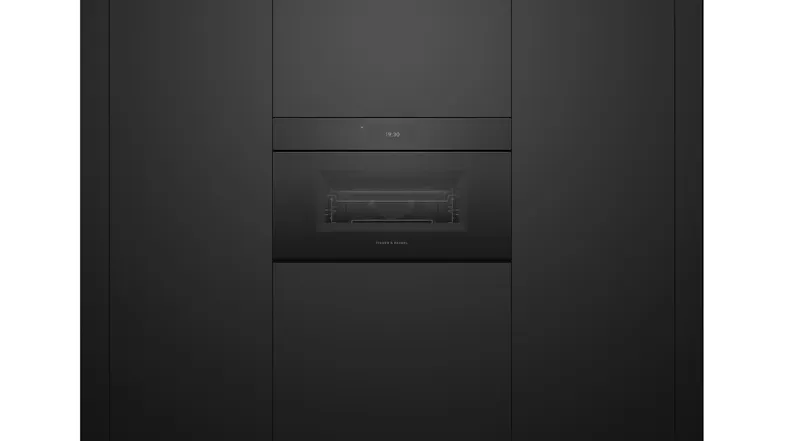 Front view of the built-in microwave oven in black glass, flush-mounted in black cabinetry with digital display Front view of the built-in microwave oven in black glass, flush-mounted in black cabinetry with digital display