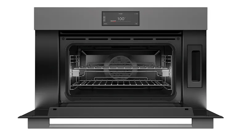 An open steam oven with racks and a 100° setting An open steam oven with racks and a 100° setting