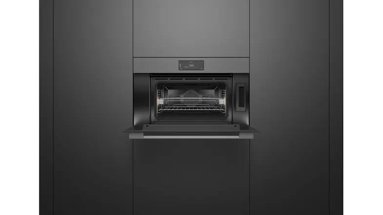 An open oven in a kitchen with a wire rack inside An open oven in a kitchen with a wire rack inside