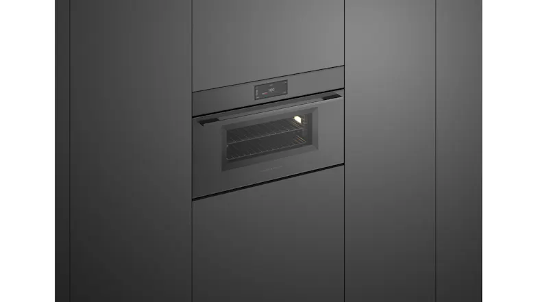Stainless oven in black cabinetry with lit interior Stainless oven in black cabinetry with lit interior