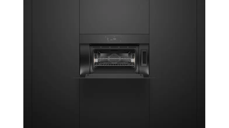 An open oven in a kitchen with a wire rack inside An open oven in a kitchen with a wire rack inside