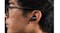 Close-up view of a person's ear wearing a wireless earbud Close-up view of a person's ear wearing a wireless earbud