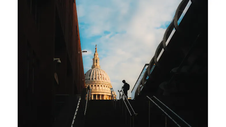 Silhouette of a person on stairs, framed by buildings with St. Paul's dome visible above Silhouette of a person on stairs, framed by buildings with St. Paul's dome visible above