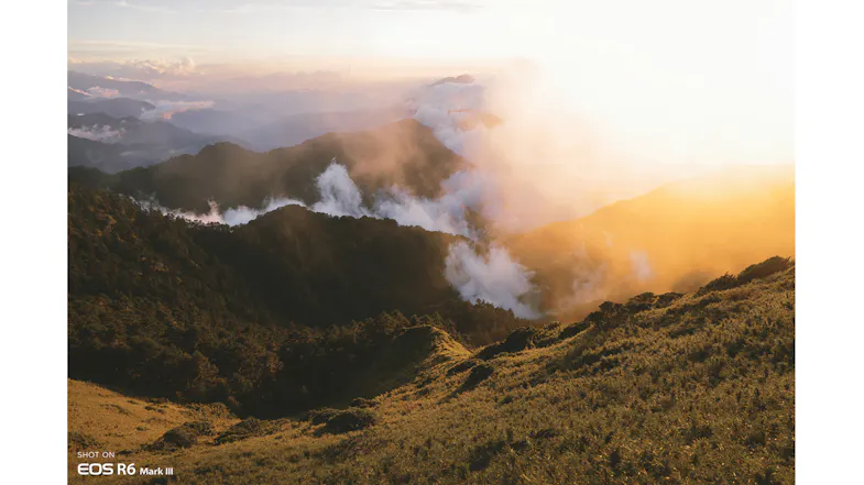 Majestic mountain landscape at sunset with fog and clouds rolling through the valleys Majestic mountain landscape at sunset with fog and clouds rolling through the valleys