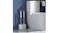 A bathroom setup with a dual toilet brush set placed beside a white toilet A bathroom setup with a dual toilet brush set placed beside a white toilet