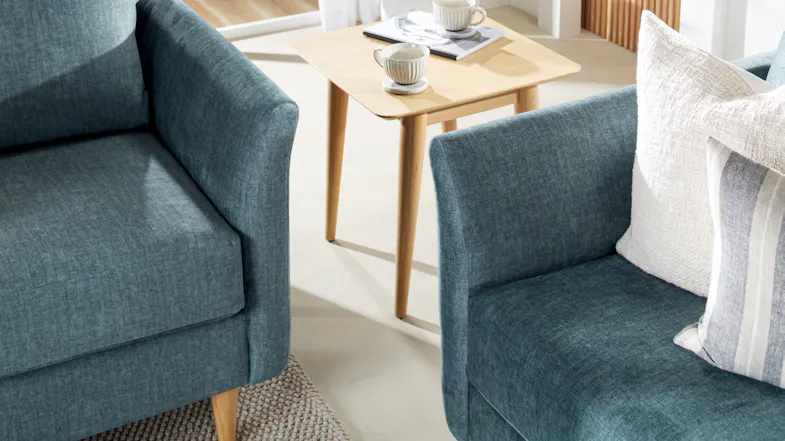 Close-up view of the Finesse Sofa’s arms with textured upholstery Close-up view of the Finesse Sofa’s arms with textured upholstery