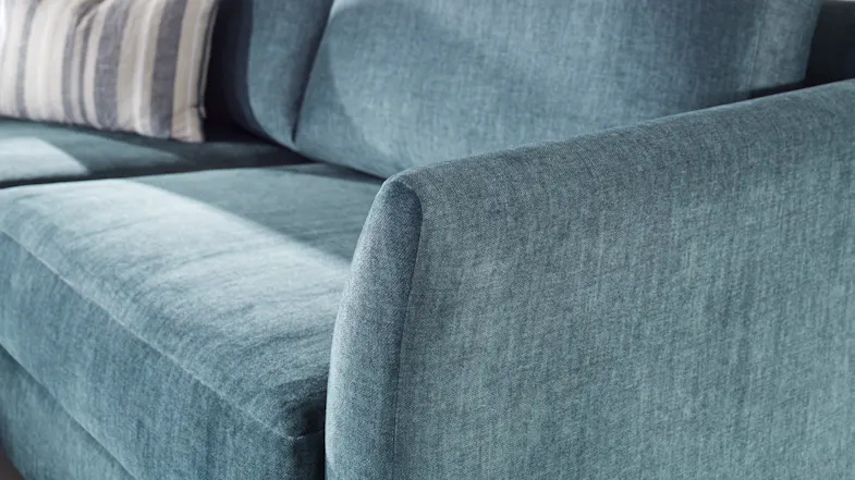 Detailed view of the textured fabric on the sofa's arm and cushions Detailed view of the textured fabric on the sofa's arm and cushions