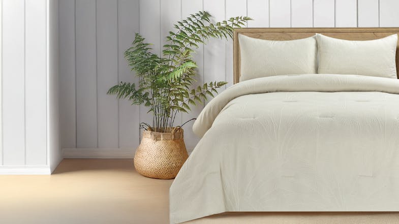 Neutral-toned bedroom with a wooden headboard, Putty coloured comforter, and a woven basket holding a green leafy plant. Neutral-toned bedroom with a wooden headboard, Putty coloured comforter, and a woven basket holding a green leafy plant.