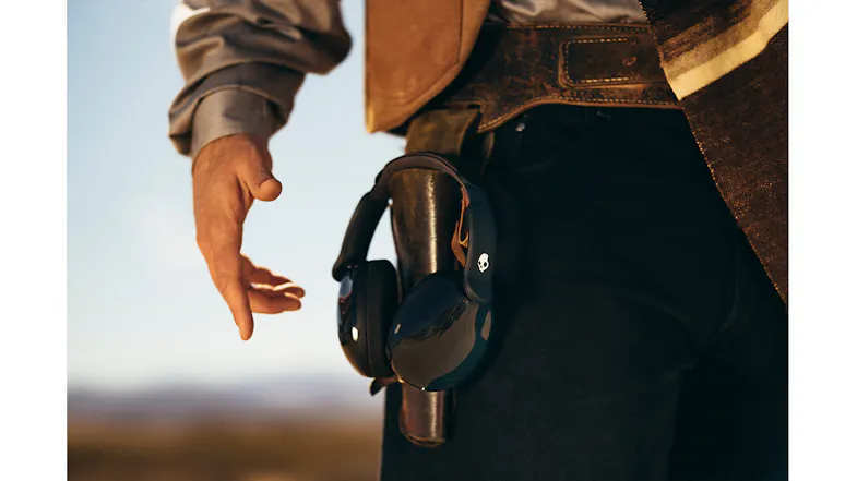 Western-style holster with Skullcandy headphones replacing a revolver Western-style holster with Skullcandy headphones replacing a revolver
