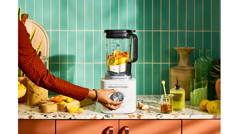 Blender with citrus and yogurt on a terrazzo counter Blender with citrus and yogurt on a terrazzo counter