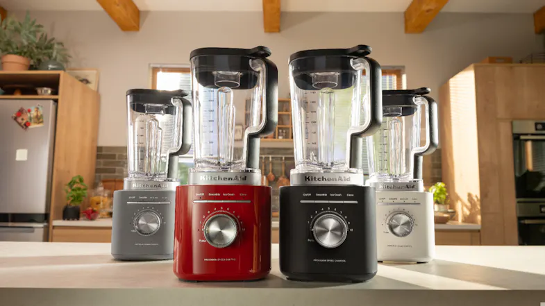 Four blenders in grey, red, black, and white on the kitchen counter Four blenders in grey, red, black, and white on the kitchen counter