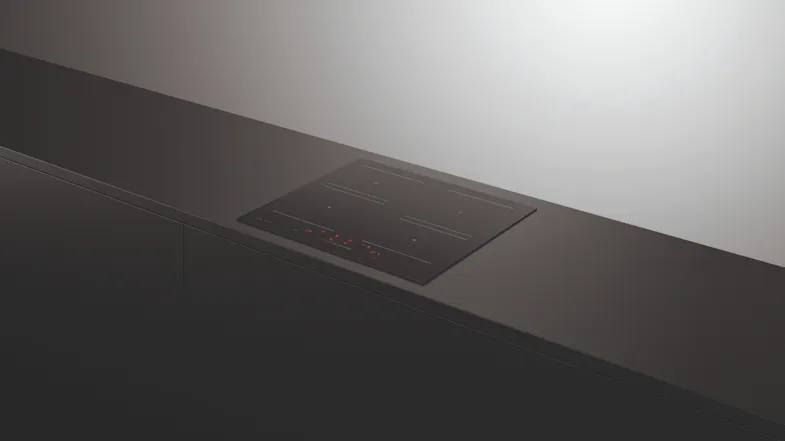 Four-zone induction cooktop on a dark counter Four-zone induction cooktop on a dark counter