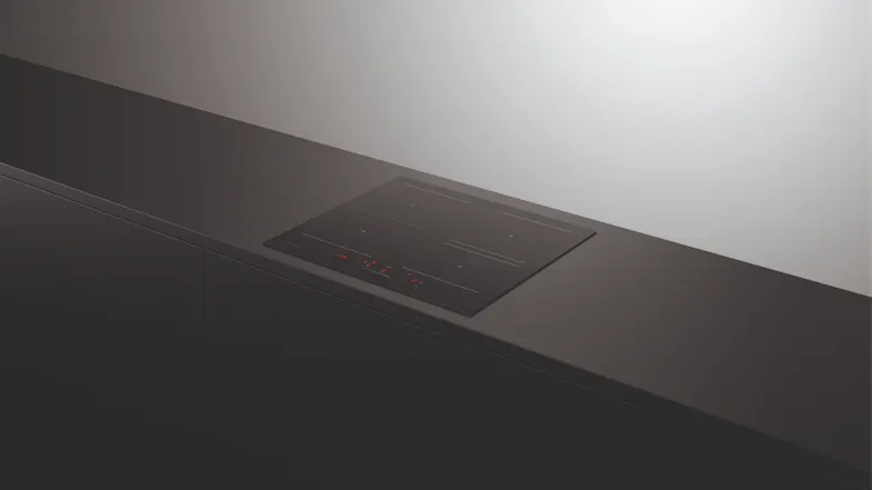 Four-zone induction cooktop on a dark counter Four-zone induction cooktop on a dark counter