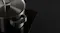 Brushed steel pot with lid on glossy black cooktop Brushed steel pot with lid on glossy black cooktop