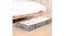 Slim grey under-bed storage bag with transparent top positioned beneath a wooden bed frame Slim grey under-bed storage bag with transparent top positioned beneath a wooden bed frame