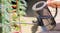 A person watering a pot in a garden A person watering a pot in a garden