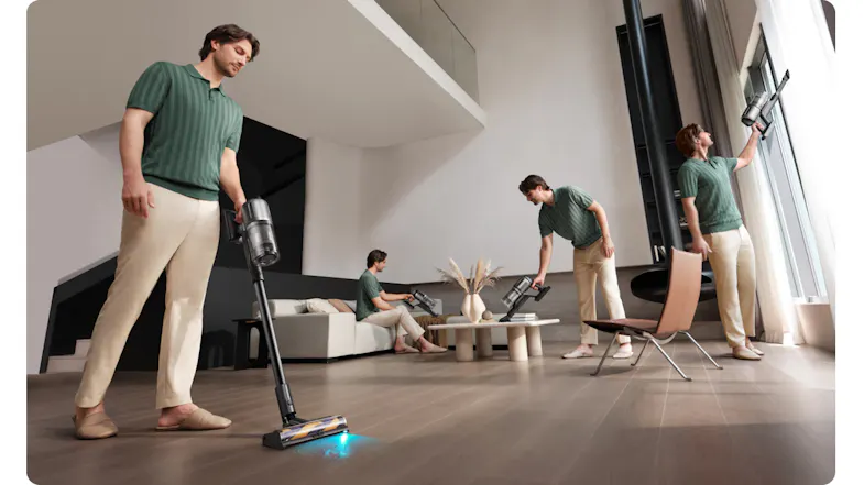 Modern living room with a person vacuuming the floor, sofa, curtains, and table Modern living room with a person vacuuming the floor, sofa, curtains, and table