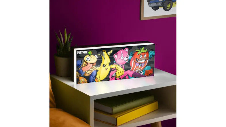 Paladone Fortnite Squad LED Character Light displayed on a white shelf in a modern room with a purple wall Paladone Fortnite Squad LED Character Light displayed on a white shelf in a modern room with a purple wall