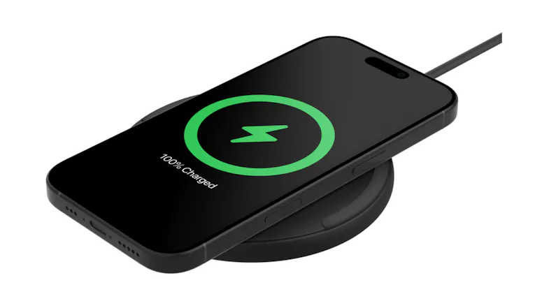 Phone on wireless pad showing 100% charged icon Phone on wireless pad showing 100% charged icon
