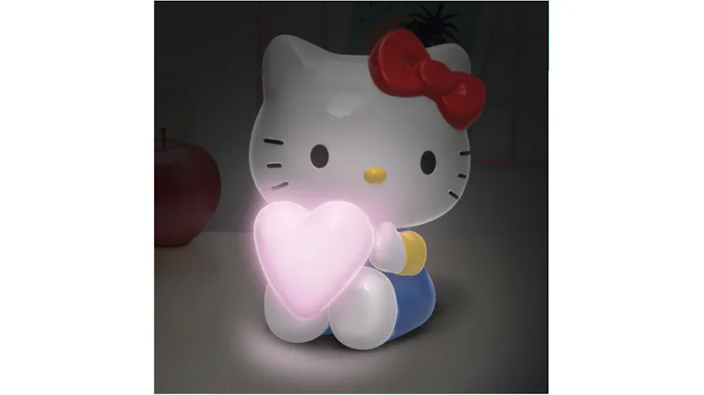 Close-up of the Hello Kitty LED light outside the box. The figure is holding a softly glowing pink heart Close-up of the Hello Kitty LED light outside the box. The figure is holding a softly glowing pink heart