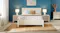 Coastal bedroom with palm bedding, blue wall, and beach art Coastal bedroom with palm bedding, blue wall, and beach art