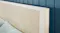 Close-up view of the headboard with blue wall and pillows Close-up view of the headboard with blue wall and pillows