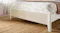 Footboard with palm mattress and brown knit blanket Footboard with palm mattress and brown knit blanket